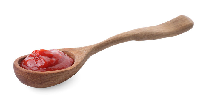 Spoon with tasty ketchup isolated on white. Tomato sauce