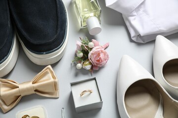 Wedding stuff. Composition with stylish boutonniere on light gray background, above view - obrazy, fototapety, plakaty