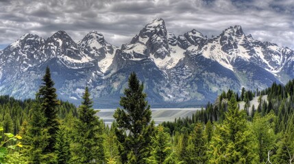 Fototapeta premium a view of a mountain range with trees in the foreground and a body of water in the foreground.