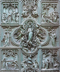 MILAN, ITALY - SEPTEMBER 16, 2024: The detail from main bronze gate of the Cathedral -   Virgin Mary with the angels by Ludovico Pogliaghi (1906). - 767516217