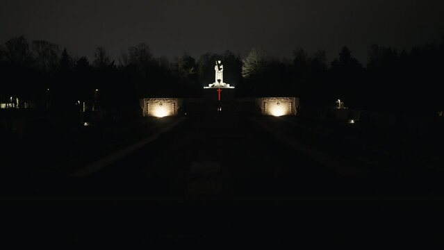 mother latvia monument: rigas bralu kapi dark stone monument entrance to large cemetery