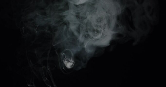 Close-Up Of Swirling Smoke Patterns On Black Background