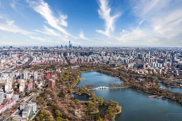 Scenery of urban buildings with blue sky and white clouds in Yuyuantan Park, Beijing