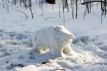 Figure of a wild boar made from snow in the park