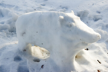Naklejka premium Figure of a wild boar made from snow in the park