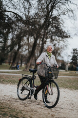 Mature woman with a joyful expression riding a bicycle on a park path, demonstrating active lifestyle and leisure.
