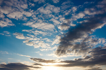 Fototapeta premium Beautiful blue sky with floating clouds at sunset background