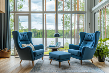 Scandinavian interior design of modern living room, home. Blue wing chairs and ottoman chair against panoramic window.