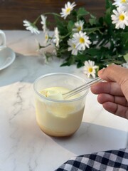 Obraz na płótnie Canvas Cream caramel pudding with caramel sauce in plate on white table