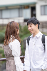 A young Taiwanese male and female couple in their 20s stare at each other in the Maokong, a tourist destination in Taiwan. 20代の若い台湾人の男女カップルが台湾の観光地である猫空でお互いを見つめ合う