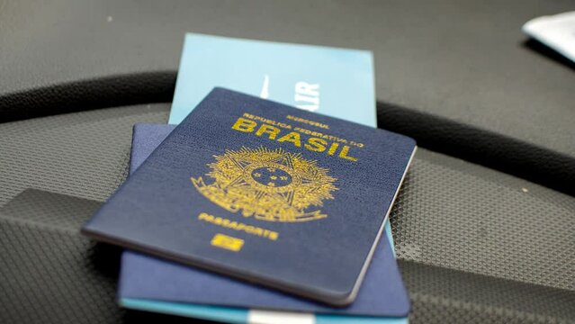 Brazilian passport highlighted on the dashboard, symbolizing travels and adventures. Exploring the world: Brazilian passport featured on the vehicle's dashboard.