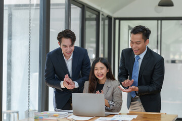 Great job! Successful business team is clapping their hands in modern workstation, celebrating the performance of new product