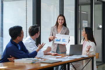 New-generation businessmen, creative professionals, and accountants meet to discuss business, brainstorm ideas, and project analysis reports. Check online investment results and company profits.