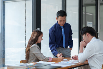 New-generation businessmen, creative professionals, and accountants meet to discuss business, brainstorm ideas, and project analysis reports. Check online investment results and company profits.