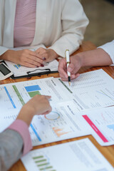 New-generation businessmen, creative professionals, and accountants meet to discuss business, brainstorm ideas, and project analysis reports. Check online investment results and company profits.