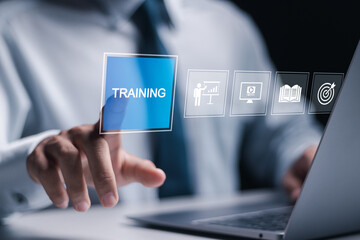 Training webinar E-learning concept. Businessman use laptop with training icon on virtual screen....