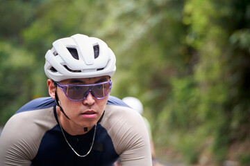 young asian adult man male cyclist riding bicycle outdoors