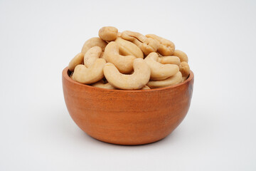 Delicious cashew nuts in a wooden bowl isolated background