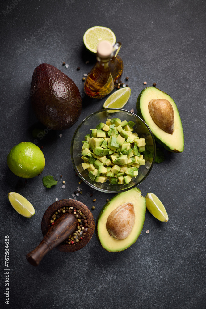 Wall mural Chopped avocado in glass bowl and avocado Halves