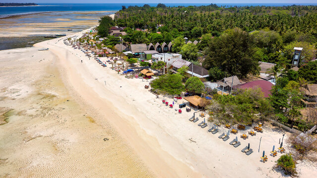 Colorful sunshades, lungers and seats on a sandy tropical beach on a small island (Gili Islands, Indonesia)