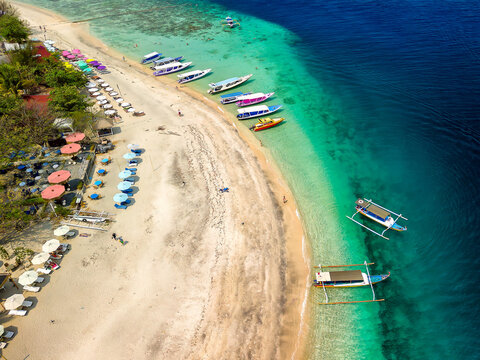 Aerial view of colorful sunshades on a tropical beach (Gili Air, Indonesia)