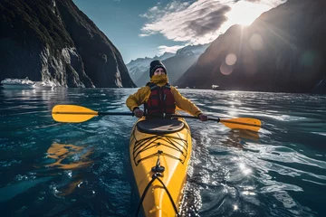 Fotobehang tourist floats on a yellow kayak along the river on the fjords. water sports and boat travel © photosaint