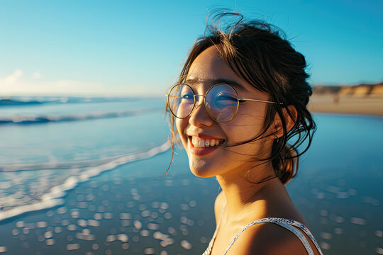 Portrait of happy smile asian young woman wear summer Sunglasses on the beach
