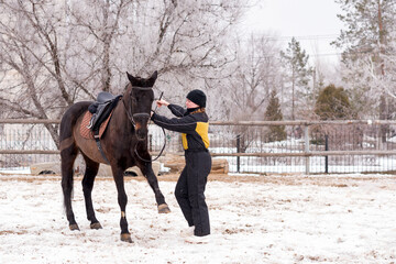 Person leading a lively horse in snow. Dressage.