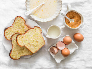 Ingredients for making baked French brioche toasts - eggs, milk, cane sugar, pieces of fresh...