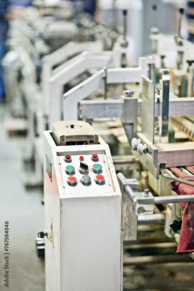 Aufkleber factory, production and machine closeup with technology in system at manufacturing warehouse. indust