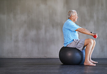 Senior man, dumbbells and exercise with ball for fitness, rehabilitation or physiotherapy at gym on...