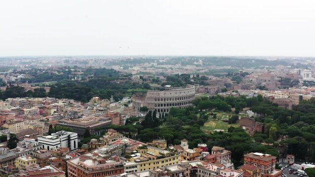 Aerial: Colosseum Amidst Residential Buildings In City Against Sky - Rome, Italy