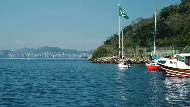 The Brazilian Flag waves at Urca's Beach in Rio de Janeiro, Brazil