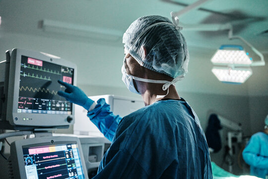 Screen, monitor or surgeon in emergency surgery, professional care and hospital for support. Press, help and doctor with heart rate tracker in operation or mask to check healthcare in medical results