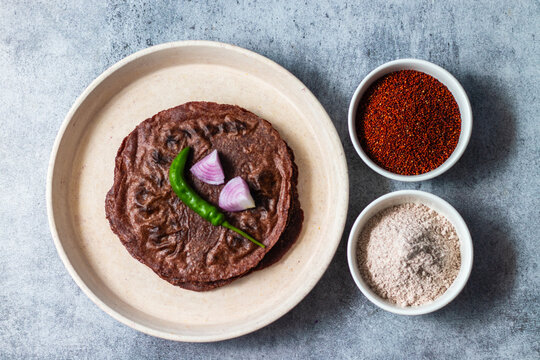healthy super food "ragi roti" with raw ragi and flour. selective focus. 