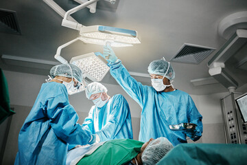 Healthcare, surgery and doctors with patient in theater for emergency medical procedure. Hospital,...