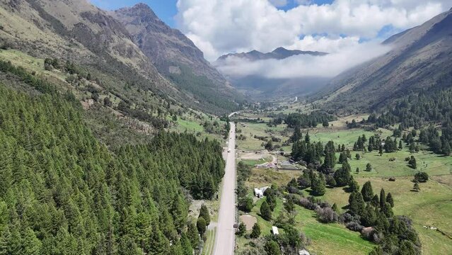 Drone Flight Over El Cajas National Park: Cloudy Day Aerial Panorama of Azuay's Mountainous Terrain and Winding Roads in Cuenca, Ecuador.