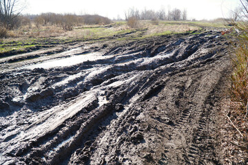 Dirty impassable country road with deep ruts