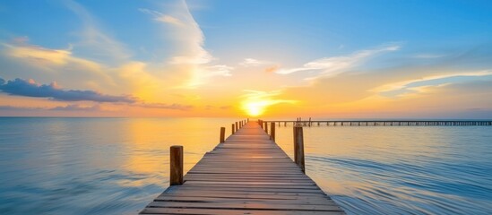 wooden bridge over the sea water to enjoy the sunset view