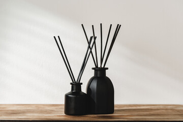 Minimalist Aromatic Reed Diffusers on a Wooden Surface Against a Soft Background