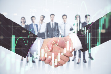 Close up of two men shaking hands with their diverse blurry colleagues in the background. Concept of business partnership, management and financial growth with forex chart. Double exposure.