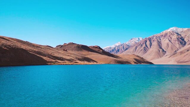 Beautiful landscape view of Chandra Taal Lake with Himalaya mountains in background at Spiti Valley, India. Summer nature landscape. Turquoise water mountain lake. 