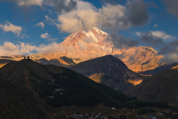 View of Kazbek from the surrounding towns. The huge peak bathed in the morning sun is impressive.