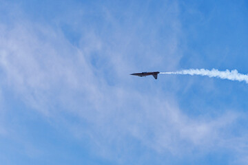 Patrouille Suisse doing aerobatics with solo fighter upside down at Swiss City of Kloten on a sunny summer day. Photo taken August 18th, 2023, Zurich Kloten, Switzerland.