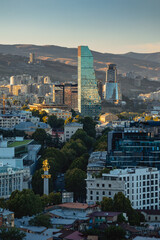 View of Tbilisi from the surrounding hills. In the background you can see the Caucasus Mountains. A warm autumn day in the capital of Georgia. - 767667471