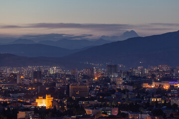 View of Tbilisi from the surrounding hills. In the background you can see the Caucasus Mountains. A...