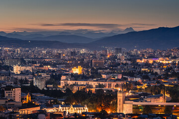 View of Tbilisi from the surrounding hills. In the background you can see the Caucasus Mountains. A warm autumn day in the capital of Georgia. - 767667656