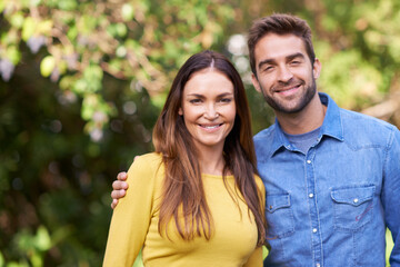 Fototapeta premium Couple, outdoor and smile with hug for bonding, love and support to relax and together. Portrait, relationship and romance with happiness or fun at park as family, soulmate and commitment