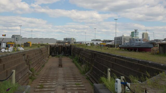 Empty Dry Dock At The Port Of Antwerp In Belgium In Daytime. pan left shot