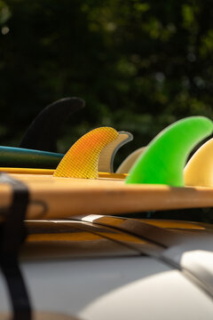 Surfboards, colorful fins, Bali atmosphere.